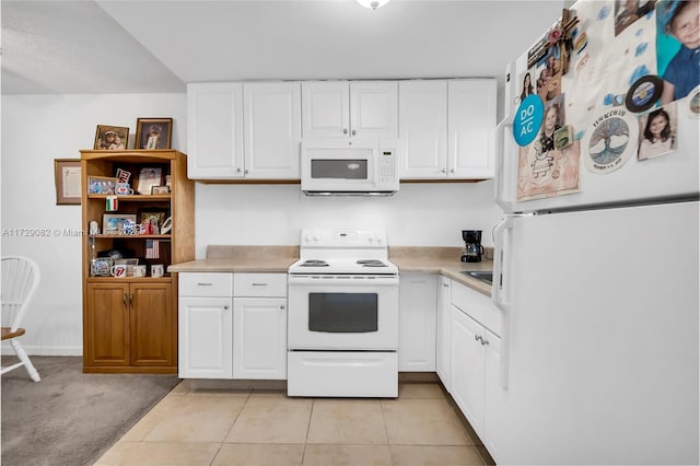 kitchen featuring white cabinetry, white appliances, and light carpet