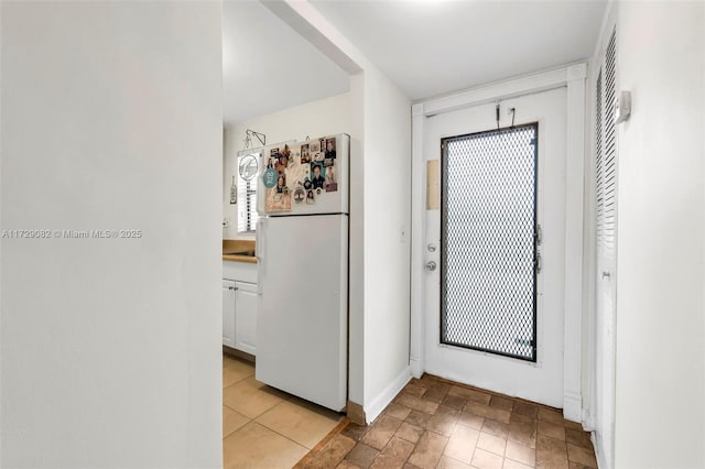 doorway with light tile patterned floors