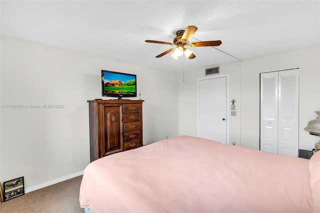 carpeted bedroom with ceiling fan and a closet