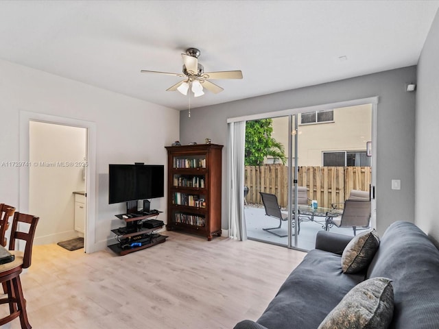 living room featuring ceiling fan and light hardwood / wood-style flooring