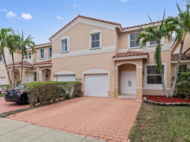 mediterranean / spanish-style house with a garage