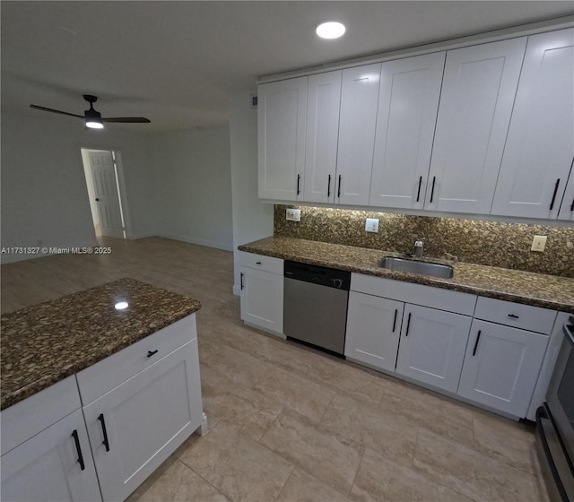 kitchen featuring white cabinetry, dark stone countertops, sink, and stainless steel dishwasher