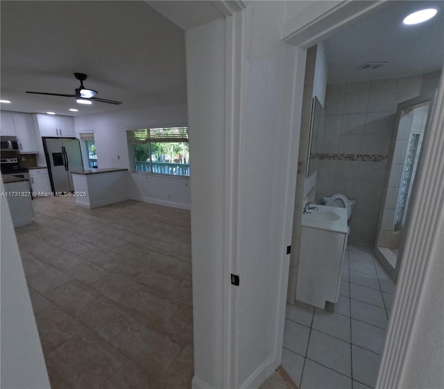 interior space with tile patterned flooring, sink, and ceiling fan