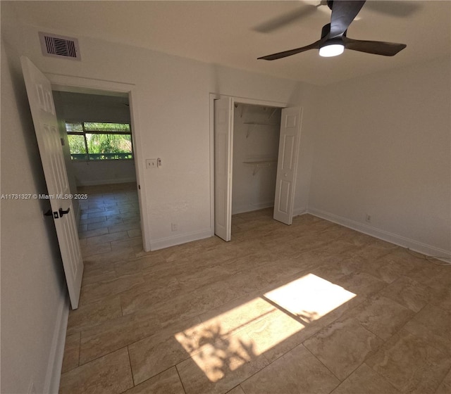 unfurnished bedroom with ceiling fan and a closet