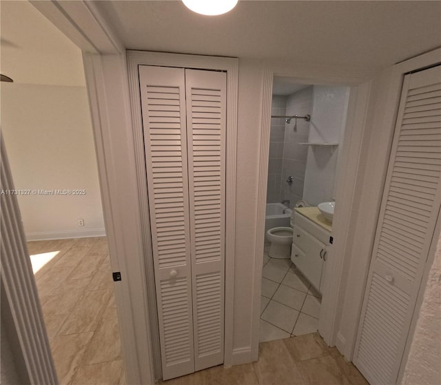 hall featuring light tile patterned flooring