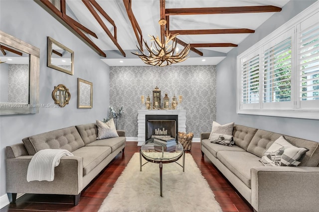 living room featuring an accent wall, a fireplace, baseboards, dark wood-style floors, and wallpapered walls