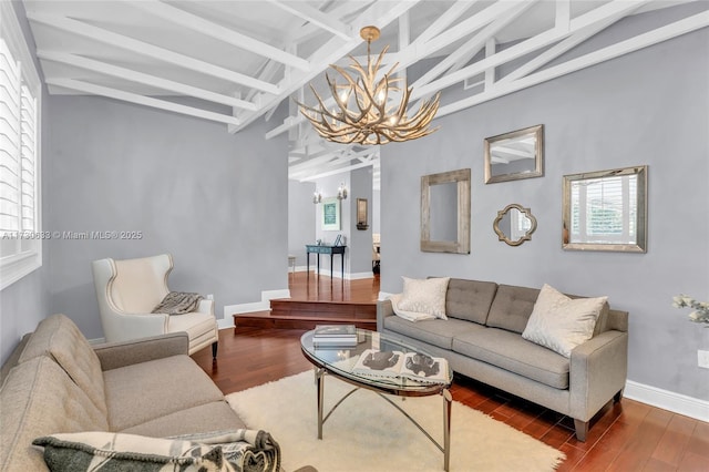 living room with baseboards, wood finished floors, vaulted ceiling with beams, and a notable chandelier