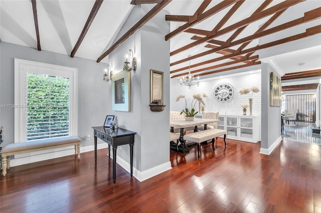 interior space with beam ceiling, an inviting chandelier, hardwood / wood-style flooring, and baseboards