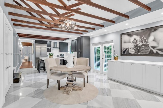 dining area with an inviting chandelier, beam ceiling, and french doors