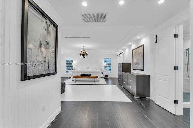 corridor featuring recessed lighting, visible vents, an inviting chandelier, and wood tiled floor