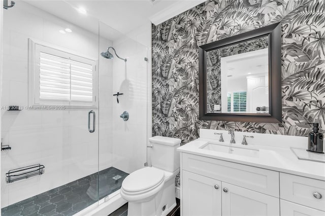 full bathroom with vanity, toilet, a shower stall, and wallpapered walls