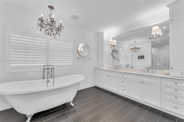 bathroom featuring crown molding, vanity, shower with separate bathtub, and a chandelier