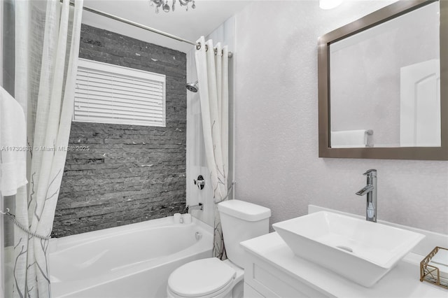 full bathroom featuring vanity, toilet, a textured wall, and shower / bath combination with curtain