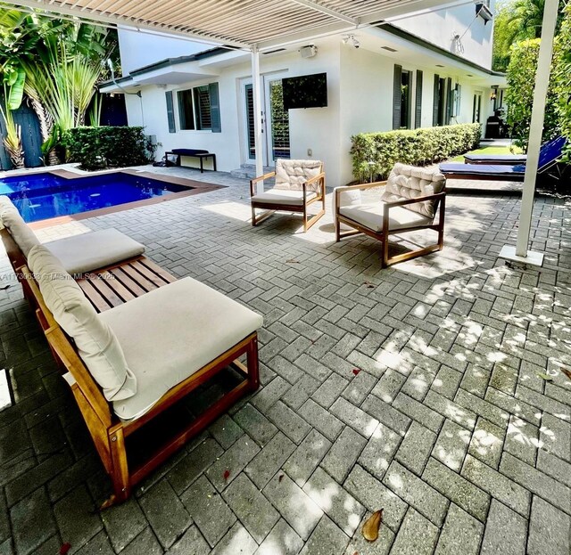 491 SW 22nd Rd, Miami, FL 33129 - view of patio featuring an outdoor living space and an outdoor pool