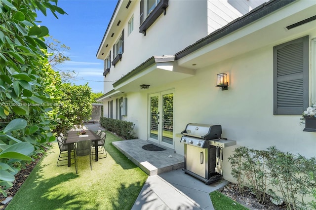 exterior space with area for grilling, french doors, and outdoor dining space