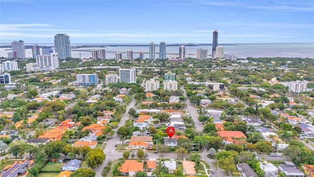 birds eye view of property featuring a water view and a city view
