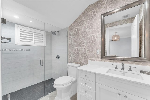 bathroom with vanity, a shower with door, and toilet