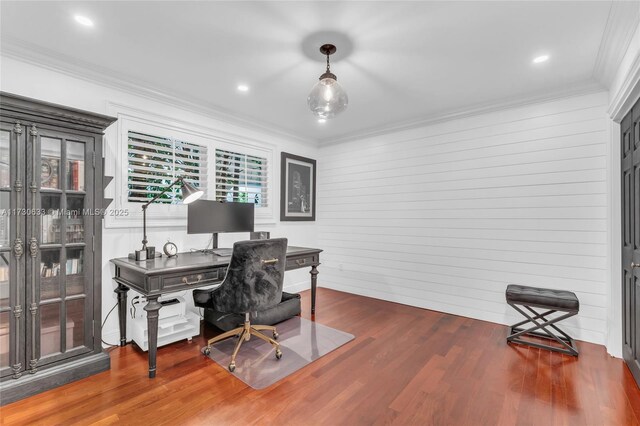 office space with wood-type flooring, ornamental molding, and wood walls