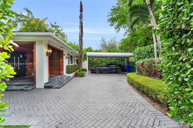 view of car parking featuring a carport and a garage