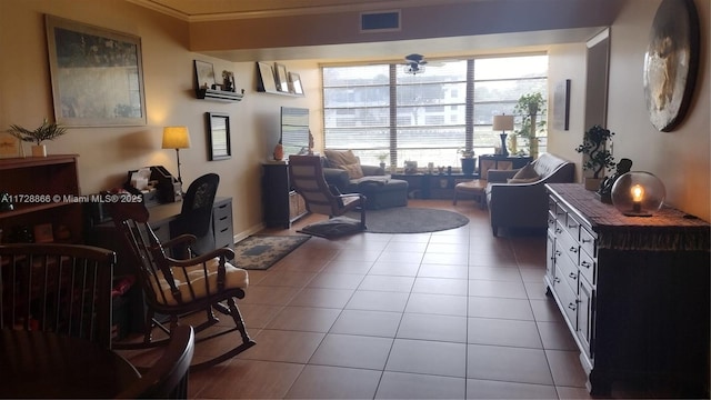 sitting room featuring ornamental molding and light tile patterned floors