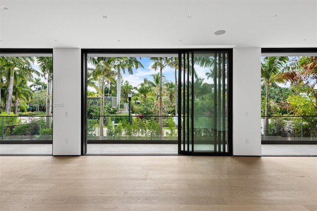 doorway to outside featuring hardwood / wood-style flooring and expansive windows