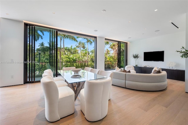 291 Palm Ave, Miami Beach, FL 33139 - dining room with light wood finished floors and expansive windows