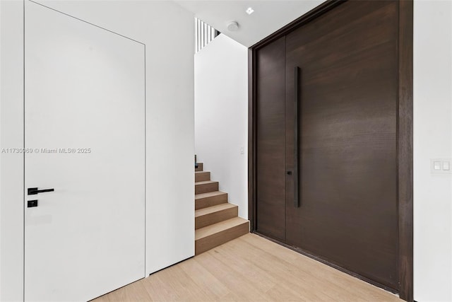 291 Palm Ave, Miami Beach, FL 33139 - corridor featuring light wood finished floors and stairs