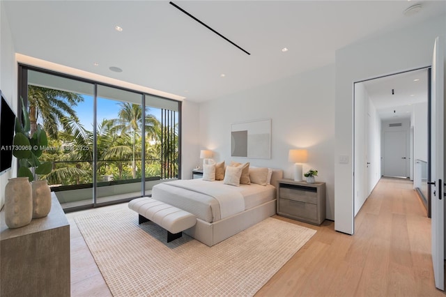 291 Palm Ave, Miami Beach, FL 33139 - bedroom featuring expansive windows, access to exterior, light wood-type flooring, and recessed lighting