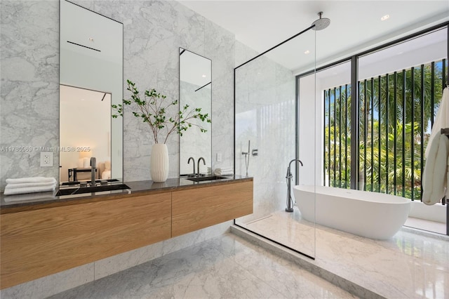 291 Palm Ave, Miami Beach, FL 33139 - full bath with marble tiled floors, double vanity, a freestanding bath, tile walls, and a shower with shower door