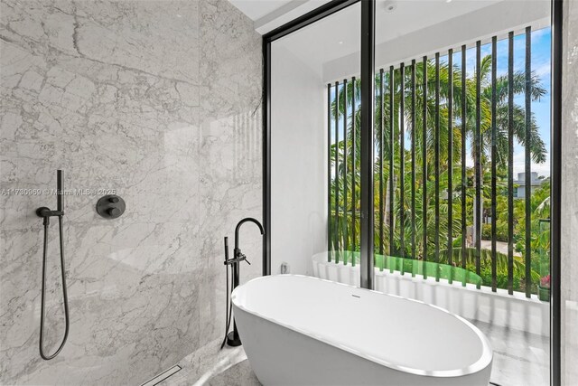 291 Palm Ave, Miami Beach, FL 33139 - bathroom featuring a soaking tub and a shower