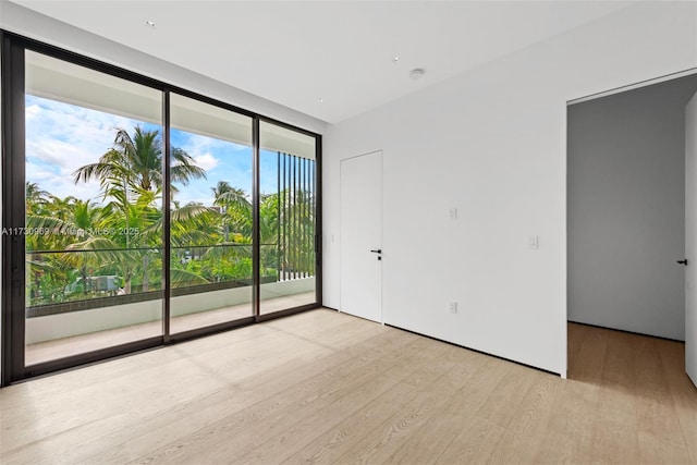 291 Palm Ave, Miami Beach, FL 33139 - empty room with wood finished floors and expansive windows