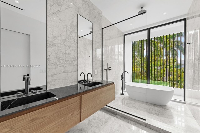 bathroom featuring vanity, tile walls, floor to ceiling windows, and a bathing tub