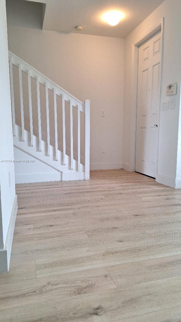 stairs with wood-type flooring