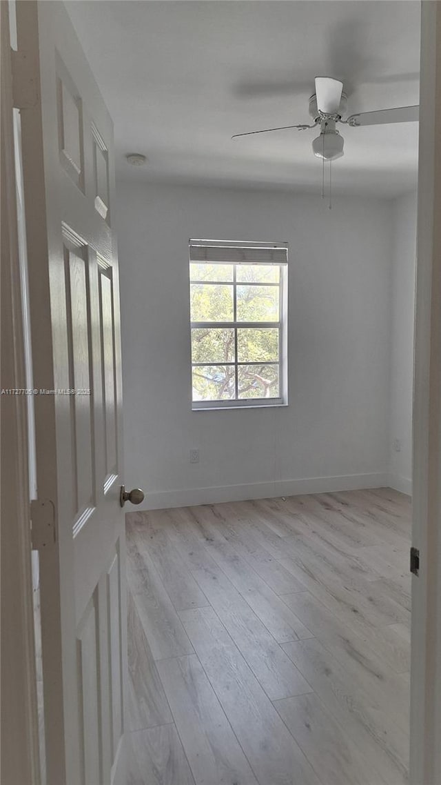 spare room featuring ceiling fan and light hardwood / wood-style floors