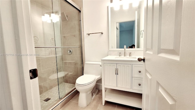 bathroom featuring tile patterned floors, toilet, an enclosed shower, and vanity