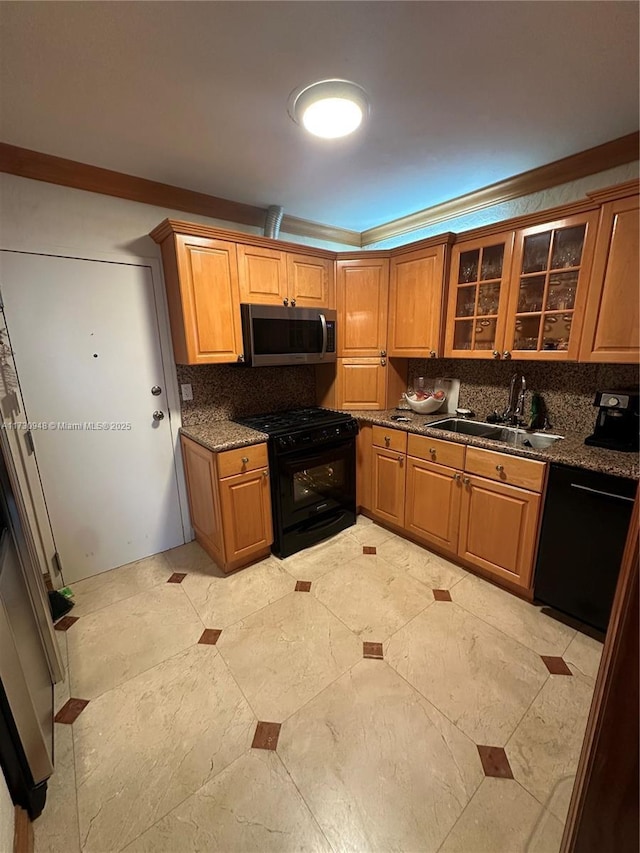 kitchen with sink, dark stone countertops, decorative backsplash, and black appliances