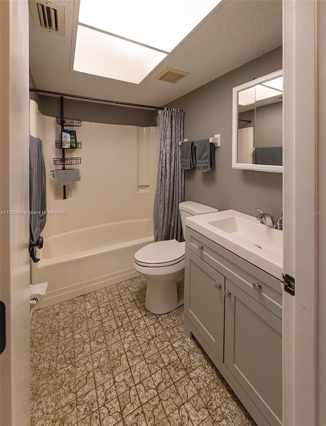 full bathroom featuring shower / bath combo, vanity, and toilet