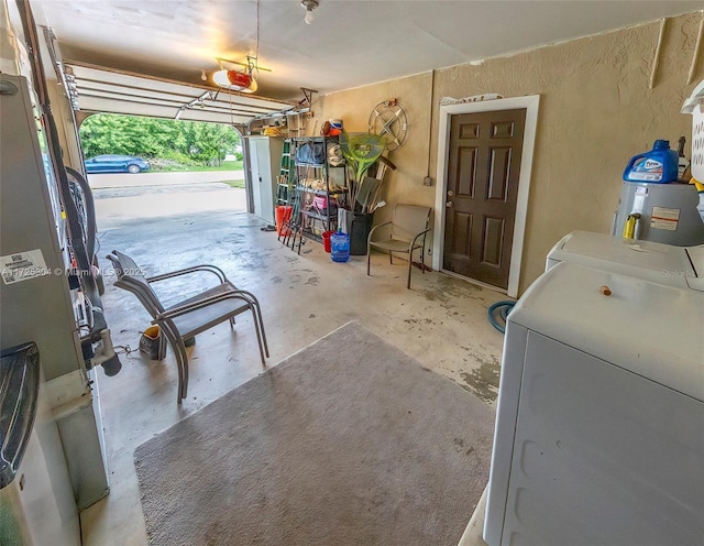 garage with a garage door opener and washing machine and dryer