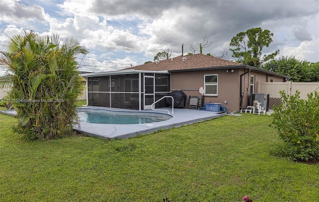 rear view of house with a sunroom and a yard