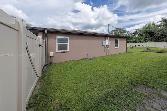 view of side of property with a yard