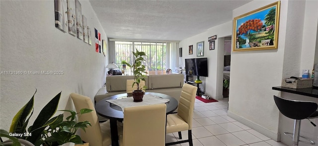 tiled dining area featuring a textured ceiling