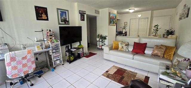 tiled living room featuring a textured ceiling