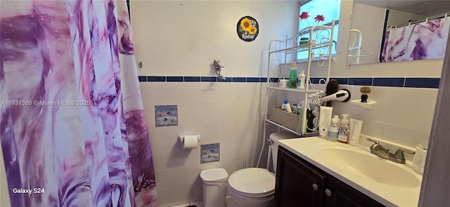 bathroom featuring vanity, tile walls, curtained shower, and toilet