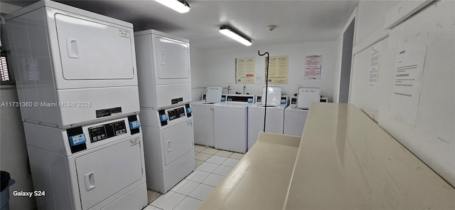 laundry area with light tile patterned flooring, stacked washer and clothes dryer, and washing machine and dryer