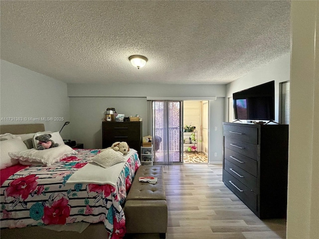 bedroom featuring light hardwood / wood-style flooring and a textured ceiling