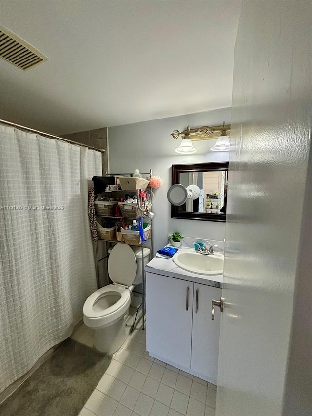 bathroom featuring tile patterned flooring, vanity, curtained shower, and toilet