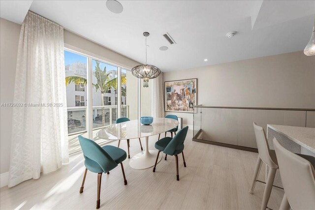 kitchen with a spacious island, a breakfast bar, sink, hanging light fixtures, and double oven