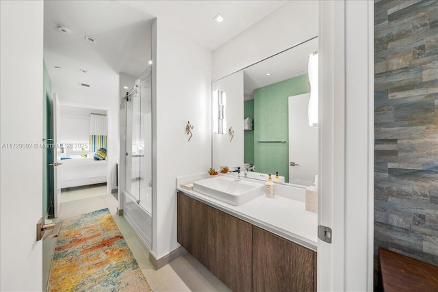 bathroom with vanity and bath / shower combo with glass door