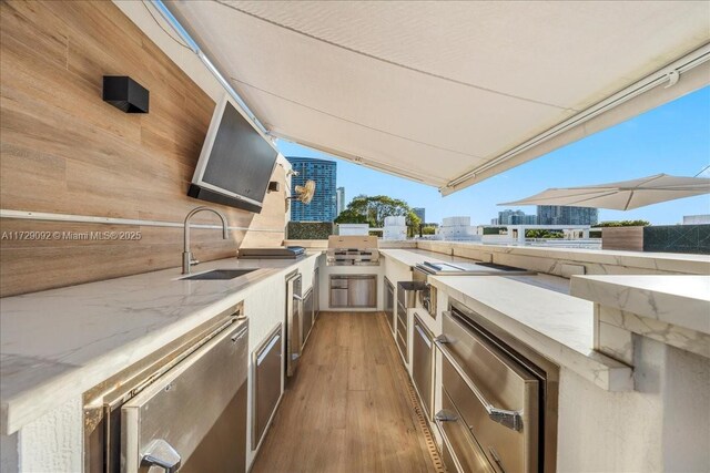 deck with an outdoor kitchen and sink