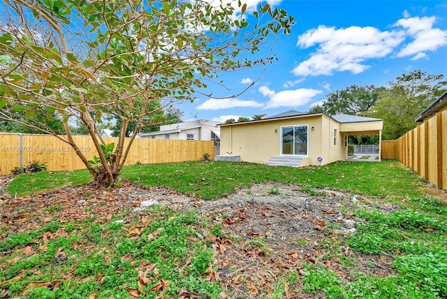 back of house featuring a yard